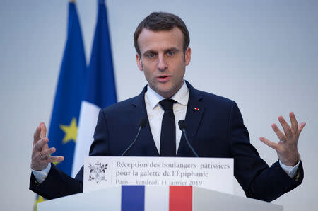 FILE PHOTO: French President Emmanuel Macron delivers a speech during a traditional epiphany cake ceremony at the Elysee palace in Paris, France, January 11, 2019. Ian Langsdon/Pool via REUTERS