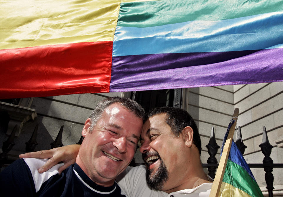 Supporters of gay marriage celebrate under the gay flag outside the Spanish parliament in Madrid, Thursday, June 30, 2005. The parliament has legalized same-sex marriage, defying conservatives and clergy who opposed making traditionally Roman Catholic Spain the third nation to take this step. (AP Photo/Jasper Juinen)