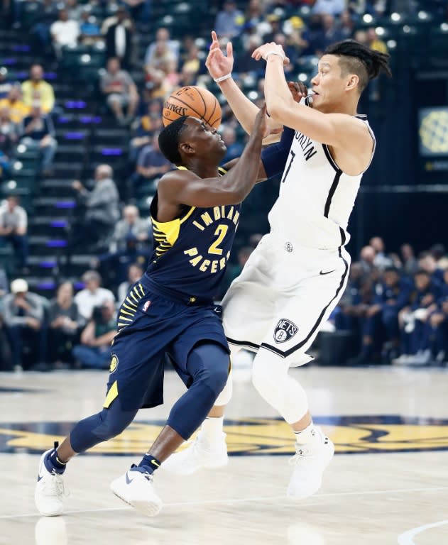 Darren Collison (L) of the Indiana Pacers and Jeremy Lin of the Brooklyn Nets fight for a loose ball at Bankers Life Fieldhouse in Indianapolis, Indiana, on October 18, 2017