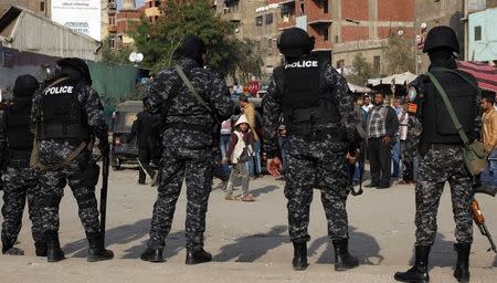 File photo of police stand guard for possible protests in the eastern suburb of Mataryia in Cairo November 28, 2014. REUTERS/Asmaa Waguih