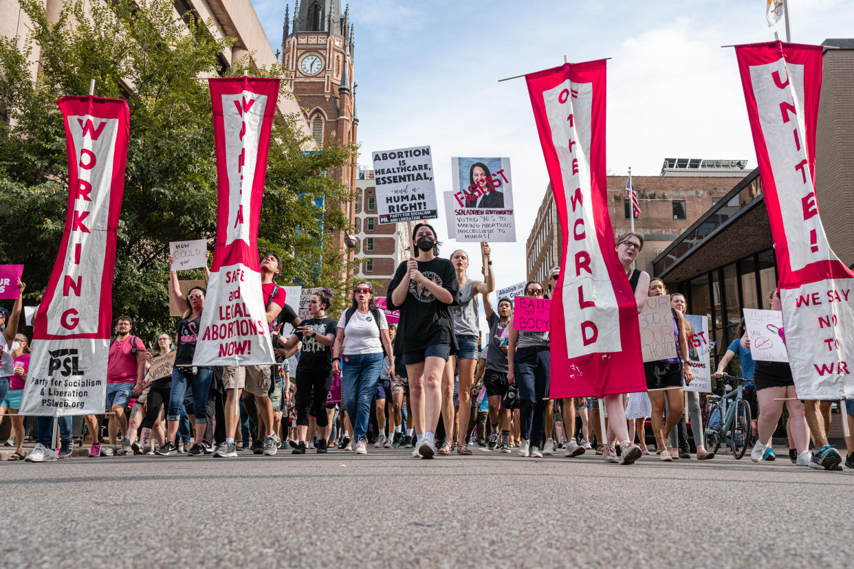 Abortion-rights protesters chant and display signs during a march in dissent of the Supreme Court's decision in the Dobbs v. Jackson Women's Health case on June 24, in Louisville, Ky. 