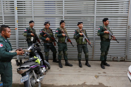 Cambodia police stand at a condo where they arrested dozens of young Chinese men and women working on a call centre to carry out a telephone and internet scam on victims in China in Phnom Penh, Cambodia, August 18, 2017. REUTERS/Samrang Pring