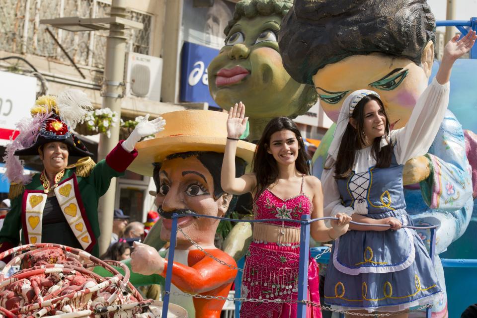 Dressed up Israelis parade on a float to celebrate the Jewish holiday of Purim on February 24, 2013 in the central Israeli city of Netanya. (Jack Guez/AFP/Getty Images)