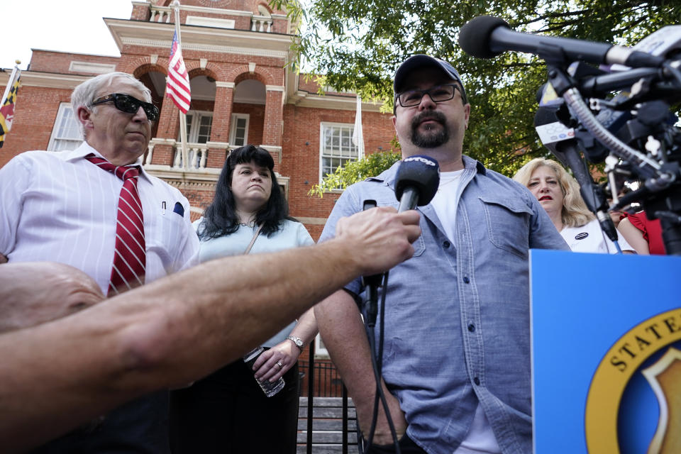 Annapolis Capital Gazette photographer Paul Gillespie, right, who survived the newsroom shooting in 2018, speaks during a press conference following a verdict in the trial of Jarrod W. Ramos, Thursday, July 15, 2021, in Annapolis, Md. The jury found the gunman who killed five people at the newspaper criminally responsible, rejecting defense attorneys' mental illness arguments. (AP Photo/Julio Cortez)