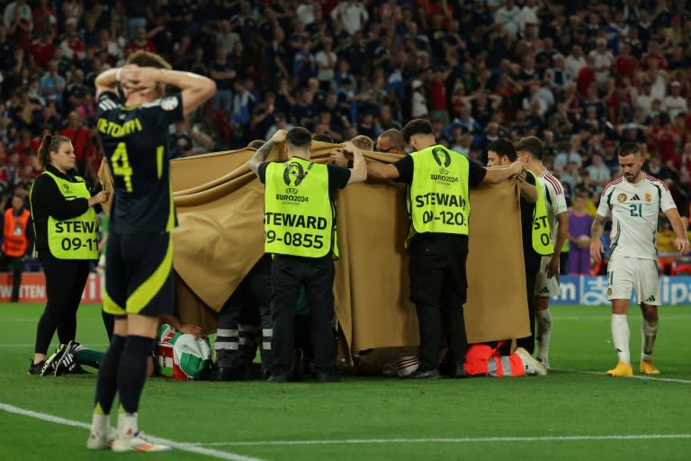 Hungarian striker Barnabas Varga, covered by blankets, receives medical attention during the Group A match of Euro 2024 in Stuttgart, June 23, 2024 (LLUIS GENE)