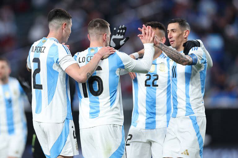 Argentina's midfielder #16 Giovani Lo Celso (2nd L) celebrates with teammates after scoring a goal during the international friendly football match between El Salvador and Argentina at Lincoln Financial Field in Philadelphia, Pennsylvania, on March 22, 2024. (Photo by Charly TRIBALLEAU / AFP)