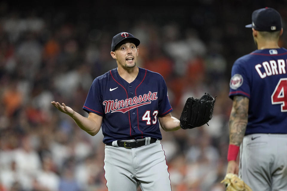 Minnesota Twins starting pitcher Aaron Sanchez (43) gestures toward Houston Astros' Jose Altuve at first base after hitting him with a pitch during the fifth inning of a baseball game Tuesday, Aug. 23, 2022, in Houston. (AP Photo/David J. Phillip)