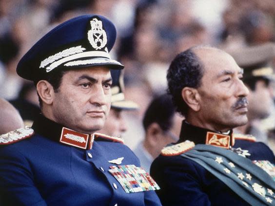 Vice President Mubarak (left) with President Anwar Sadat shortly before Sadat was assassinated by soldiers during a parade in Cairo in October 1981 (AP)