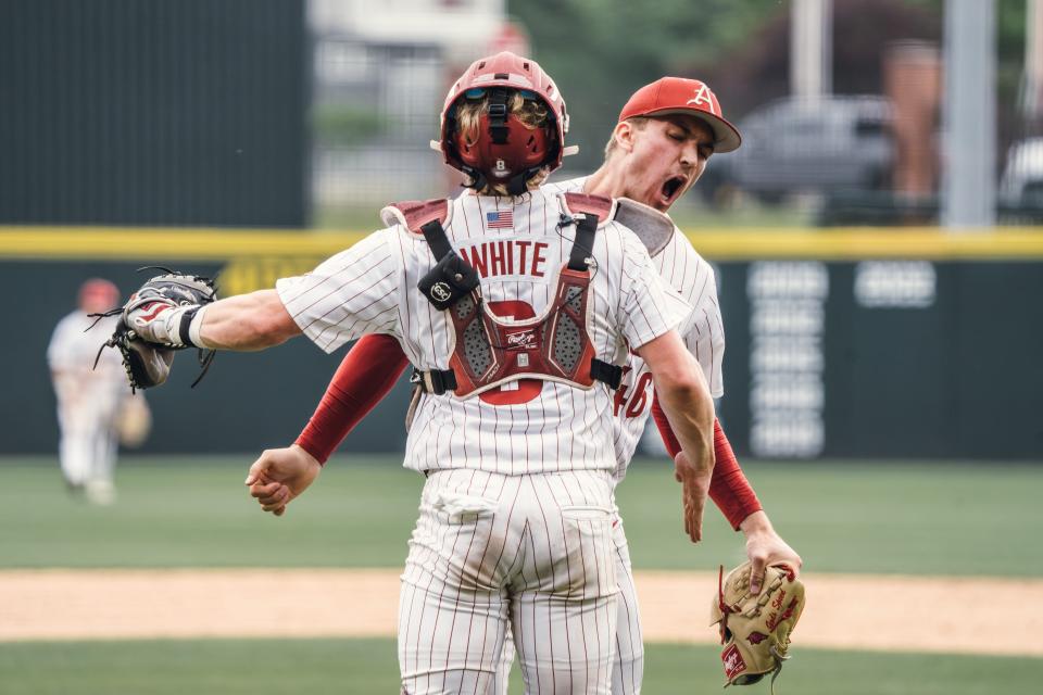Arkansas baseball's Christian Foutch and Hudson White celebrate after Foutch recorded the final out of the Hogs' 6-5 win over Florida Saturday, April 27, 2024.