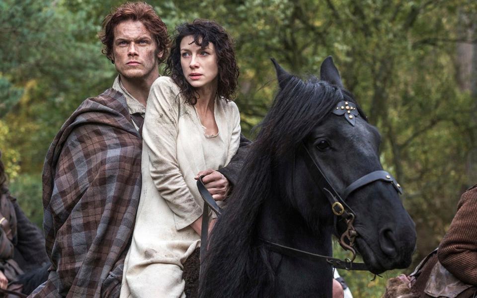 Sam Heughan as Jamie Fraser and Caitriona Balfe as Claire Randall in Outlander - AP