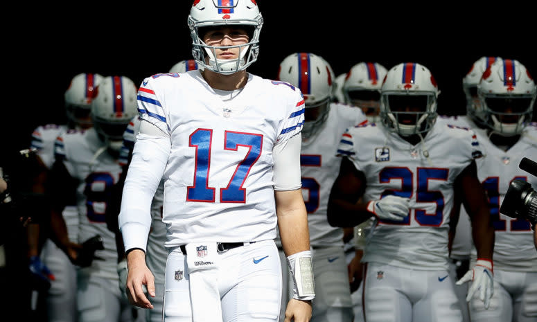 Josh Allen leading the Bills onto the field for an NFL game.