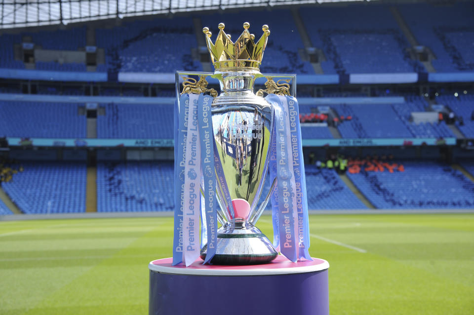 FILE - In this Sunday, May 6, 2018 file photo, the English Premier League trophy is displayed on the pitch prior to the English Premier League soccer match between Manchester City and Huddersfield Town at Etihad stadium in Manchester, England. A Bournemouth player is one of two positive tests for COVID-19 to emerge from the Premier League’s second round of testing, the club said on Sunday, May 24, 2020. The team said “medical confidentiality means the player’s name will not be disclosed” and added that he will self-isolate for seven days before being tested again at a later date. The league tested 996 players and club staff on Tuesday, Thursday, and Friday. (AP Photo/Rui Vieira, File)