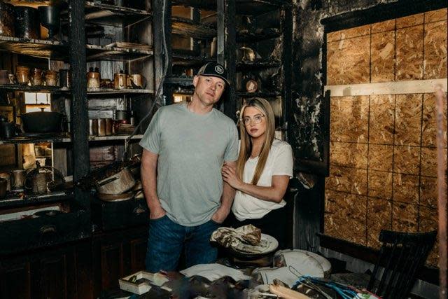 AJ and Lindsay Rowe take a "before" shot inside their Deerfield Township farmhouse, destroyed by a fire last March.