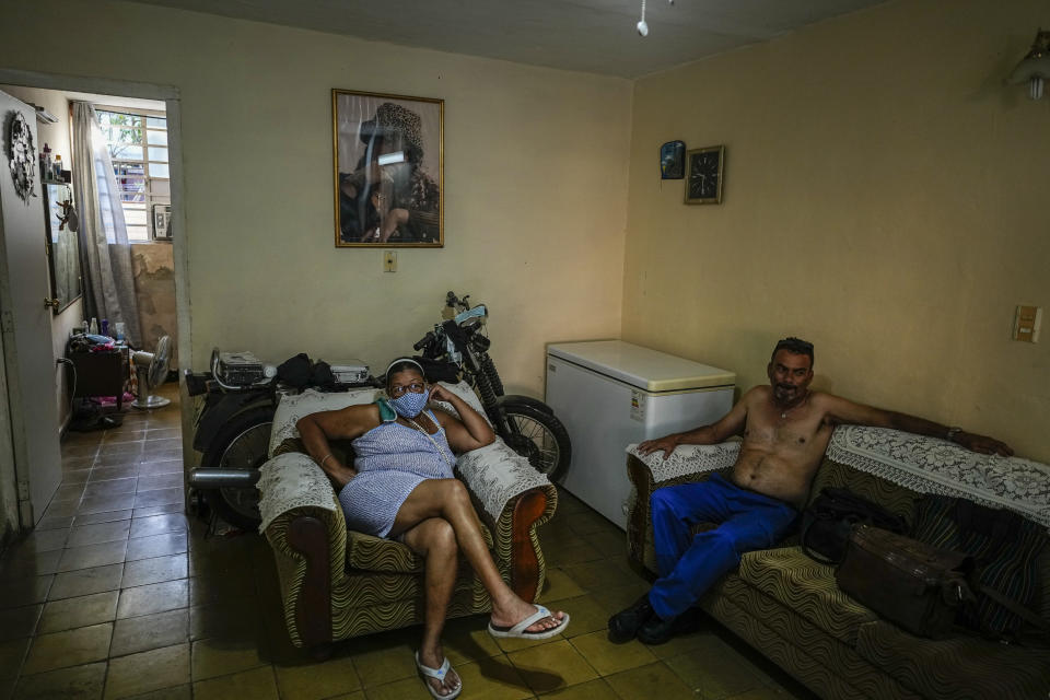 Carmen Morales and her son Angel Rodriguez sit at home in the BahÌa neighborhood in Havana, Cuba, Wednesday, May 18, 2022. Rodriguez's wife, Marylin Alvarez, began transforming part of her house into a tiny cafe with the help of money sent by a cousin living in the U.S. during President Barack Obama's administration, but it fell apart when President Donald Trump's administration tightened the embargo and sharply restricted money transfers to Cuba in late 2020, which turned Alvarez to a less costly form of making money for her family — giving manicures. (AP Photo/Ramon Espinosa)