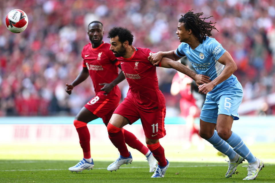 LONDON, ENGLAND - APRIL 16: Mohamed Salah of Liverpool tangles with Nathan Ake of Manchester City during The Emirates FA Cup Semi-Final match between Manchester City and Liverpool at Wembley Stadium on April 16, 2022 in London, England. (Photo by Marc Atkins/Getty Images)