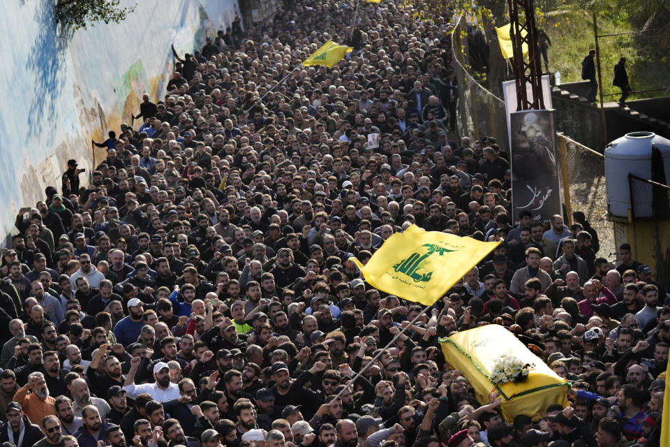 Mourners carry the coffin of senior Hezbollah commander Wissam al-Tawil during his funeral procession in the village of Khirbet Selm, south Lebanon, Tuesday, Jan. 9, 2024. The elite Hezbollah commander who was killed in an Israeli airstrike Monday in southern Lebanon fought for the group for decades and took part in some of its biggest battles. (AP Photo/Hussein Malla)