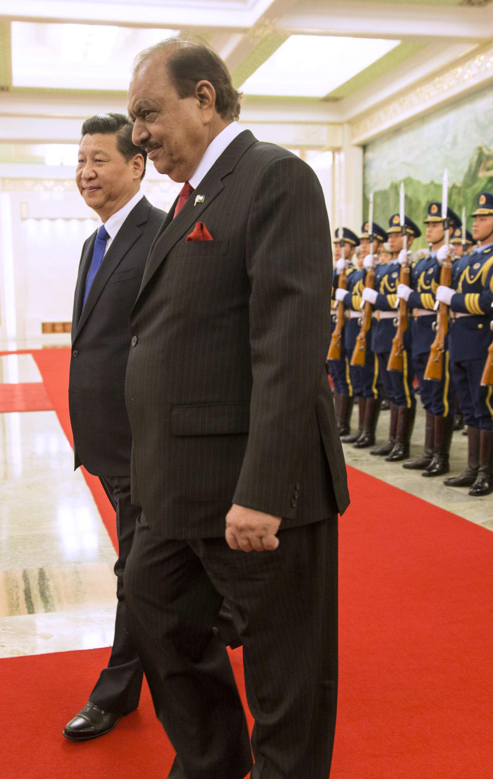 Pakistan's President Mamnoon Hussain, right, attends a welcoming ceremony with Chinese President Xi Jinping at the Great Hall of the People in Beijing, China, Wednesday, Feb. 19, 2014. Pakistani President Hussain is scheduled to meet Chinese leaders on a visit to Beijing focused on winning assistance for his country's ailing economy. (AP Photo/Adrian Bradshaw, Pool)