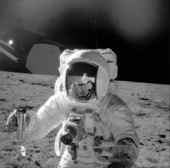 Astronaut Alan Bean collects lunar soil.