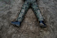 A recruit lies on the ground during his 16-day basic training for Poland's Territorial Defence Forces, at a shooting range near Siedlce, Poland, December 7, 2017. REUTERS/Kacper Pempel/Files