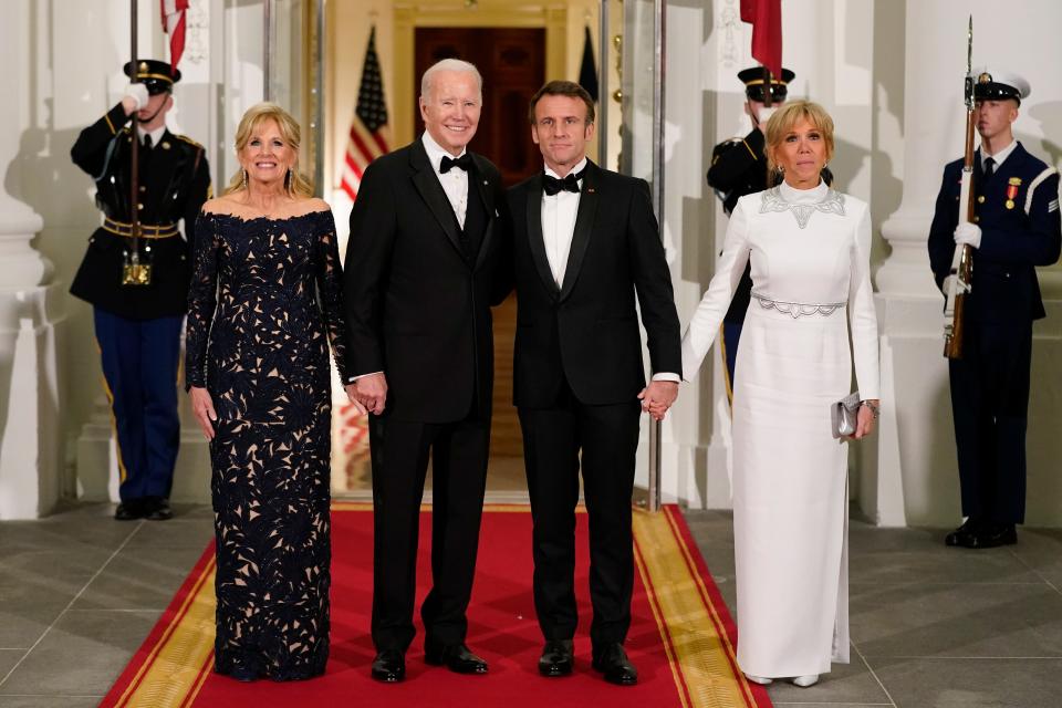 President Joe Biden and first lady Jill Biden pose for photos with French President Emmanuel Macron and his wife Brigitte Macron as they arrive for the state dinner in Washington on Dec. 1.