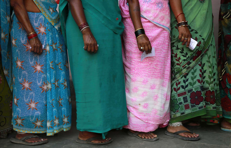 Indian women stand in a queue to cast their votes in Rajnandgaon, in the central Indian state of Chhattisgarh, now the center of India's four-decade Maoist insurgency, Thursday, April 17, 2014. Indians cast ballots Thursday on the biggest day of voting in the country's weekslong general election, streaming into polling stations even in areas where rebels threatened violence over the plight of India's marginalized and poor. The state of Chhattisgarh itself was formed only in 2000, carved from its western neighbor Madhya Pradesh based on its large tribal population. (AP Photo/Rafiq Maqbool)