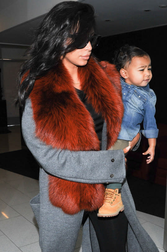 North West in denim, army pants, and Timberland boots.