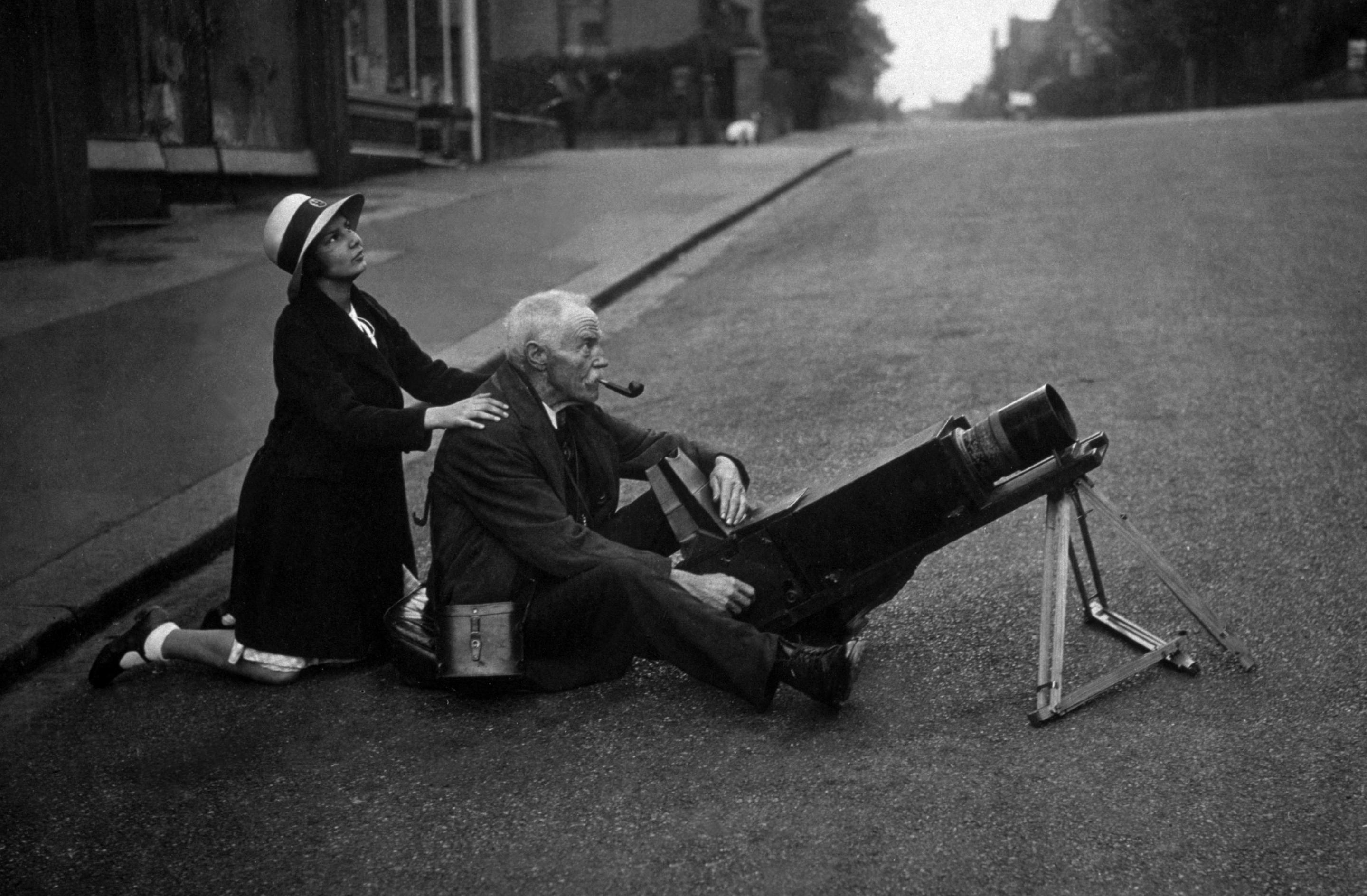 1936: An amateur astronomer photographs an eclipse of the sun from the middle of a road. 