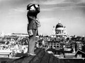 <p>An aircraft spotter stands on the roof of a building in London with St Paul’s Cathedral in the background, circa 1941. (Popperfoto/Getty Images)</p>