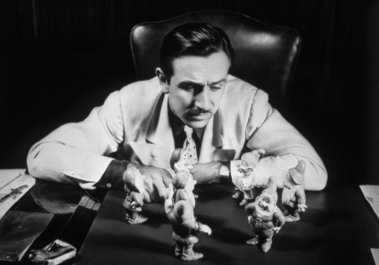 American animator and producer Walt Disney and figurines of the seven dwarfs from Snow White (1937