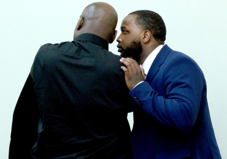 Danron Morrisey (right) speaks with his uncle Marcus Morrisey during their trial before Superior Court Judge Marc C. LeMieux in Freehold Friday, January 27, 2023.  They are charged in the 2018 murder in Neptune of Randolph Goodman.  