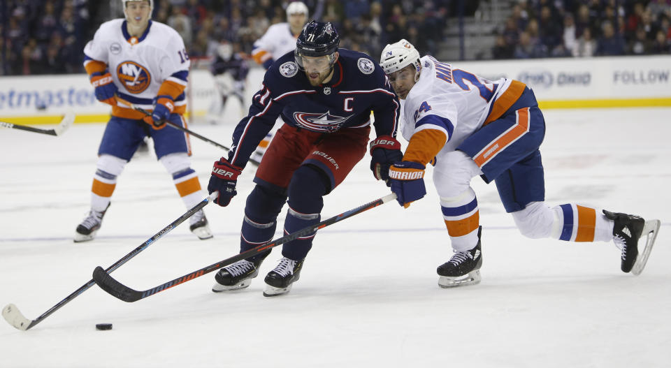 Columbus Blue Jackets' Nick Foligno, left, carries the puck upice as New York Islanders' Scott Mayfield defends during the second period of an NHL hockey game Thursday, Feb. 14, 2019, in Columbus, Ohio. (AP Photo/Jay LaPrete)