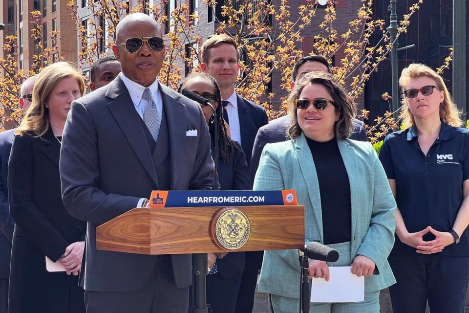 New York Mayor Eric Adams, left, introduces Kathleen Corradi, center, as the city's first-ever citywide director of rodent mitigation, also known as the 