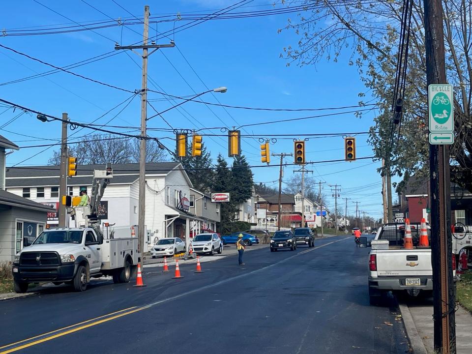 Workers from Dixon Electric, in Claysburg, install new stop lights and crosswalk lights Tuesday at the intersection of Route 403 and Campus Ave. in Davidsville. The work is part of a two-year project that will resurface Route 403 from Route 219 to the Somerset/Cambria county line in Benscreek, as well as replace several small bridges and install a retaining wall to fix a slide issue on a section of route 403 next to the Stonycreek River, near Benscreek.