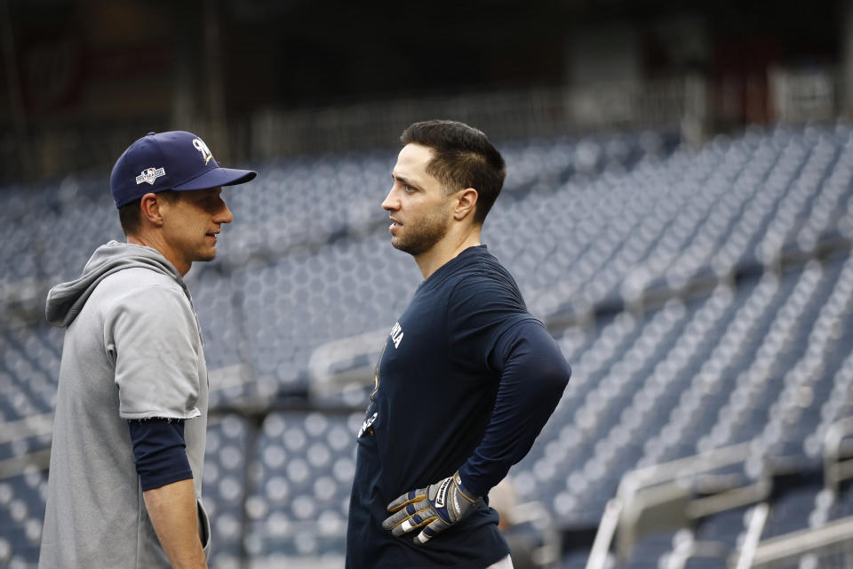 Milwaukee Brewers manager Craig Counsell, left, speaks with left fielder Ryan Braun during batting practice, Monday, Sept. 30, 2019, in Washington. The Brewers are scheduled to face the Washington Nationals in a National League wild-card baseball game Tuesday, Oct. 1. (AP Photo/Patrick Semansky)