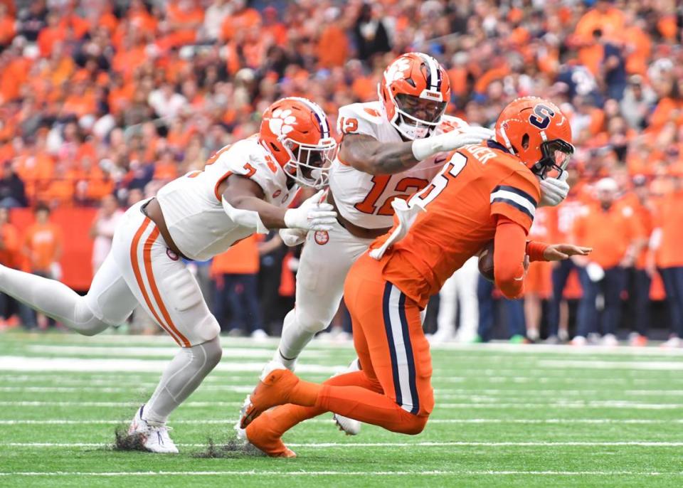 Clemson Tigers defensive end T.J. Parker (12) and defensive end Justin Mascoll (7) sack Syracuse Orange quarterback Garrett Shrader (6) in the first quarter at the JMA Wireless Dome.