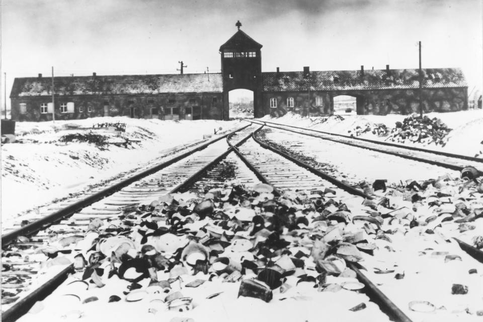 FILE- This February/March 1945, file photo shows the entry to the concentration camp Auschwitz-Birkenau in Poland, with snow covered rail tracks leading to the camp. Israel is hoping the U.N. General Assembly will unanimously adopt a resolution rejecting and condemning any denial of the Holocaust and urging all nations and social media companies "to take active measures to combat antisemitism and Holocaust denial or distortion." The 193-member world body is scheduled to vote Thursday, Jan. 20, 2022, on the resolution, which is strongly supported by Germany. (AP Photo/Stanislaw Mucha, File)