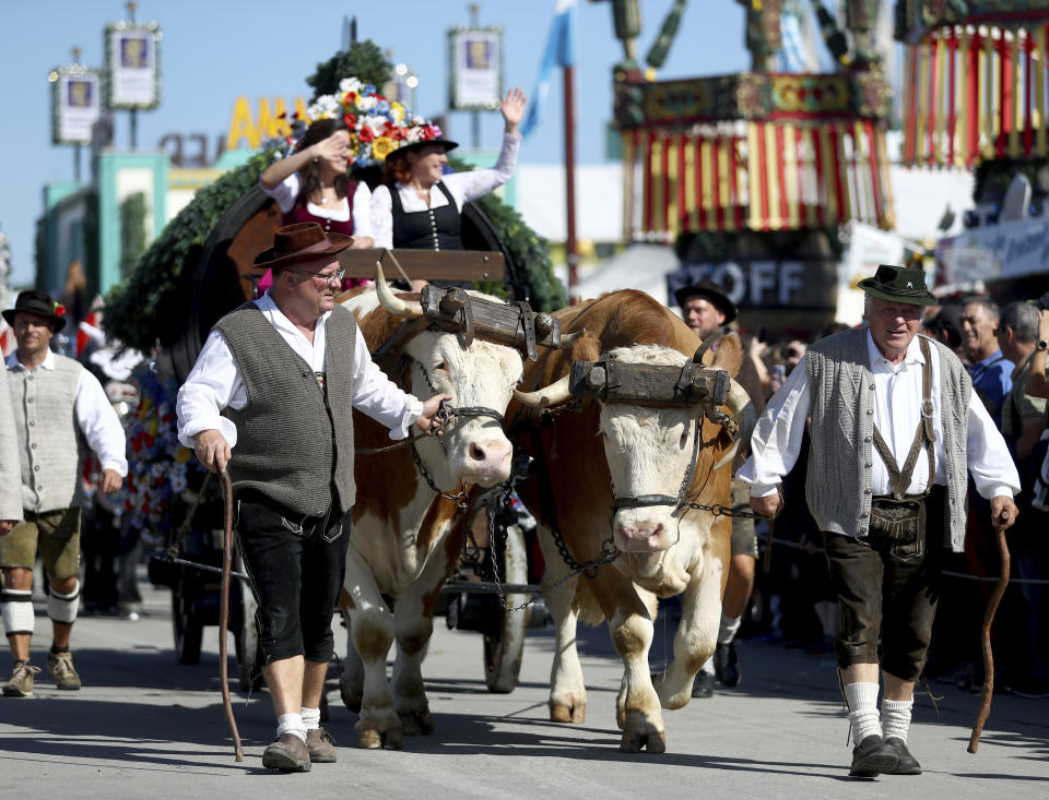 People in traditional costumes take part in a parade as part of the opening of the 186th 'Oktoberfest' beer festival in Munich, Germany, Saturday, Sept. 21, 2019. (AP Photo/Matthias Schrader)