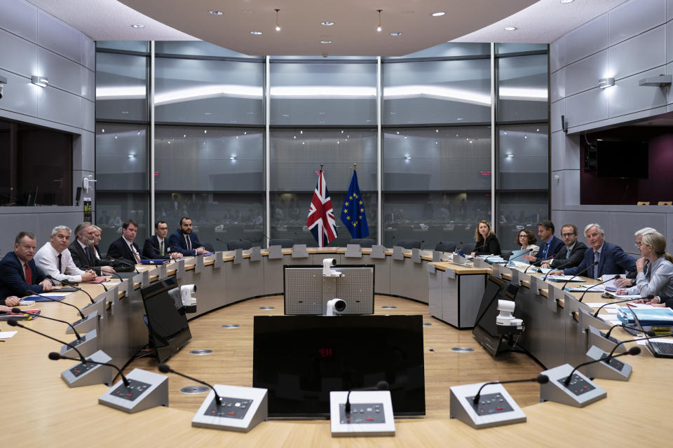 Britain's Brexit Secretary Stephen Barclay, second left, sits along with his team during a meeting with European Union chief Brexit negotiator Michel Barnier, second right, at the European Commission headquarters in Brussels, Friday, Sept. 20, 2019. (Kenzo Tribouillard/Pool via AP)