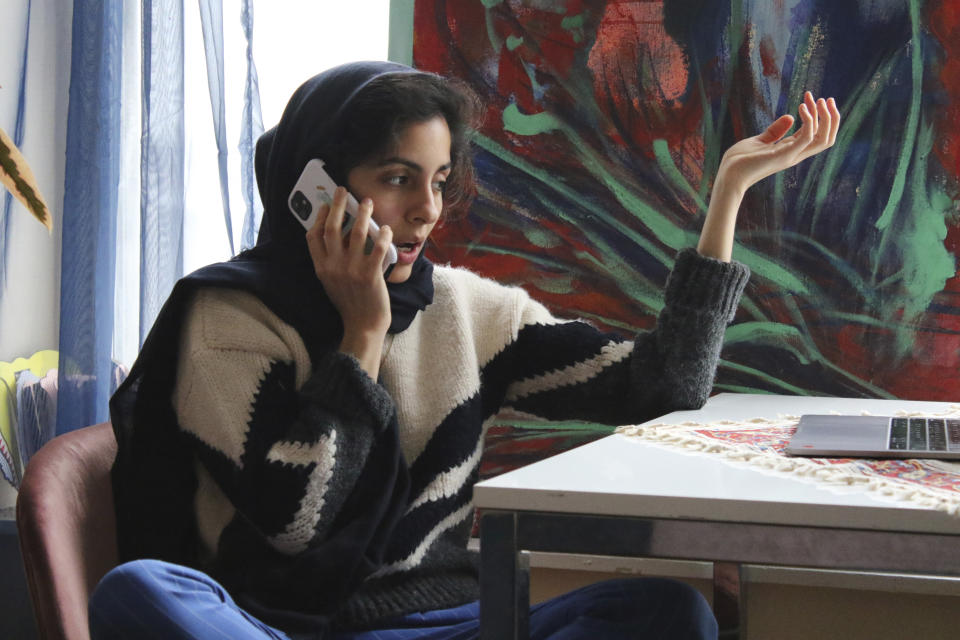 Iranian American activist Hoda Katebi, 24, speaks to another activist on Jan. 12, 2020 in her Chicago apartment. She and her network had received word that morning that an Iranian student was being detained at O'Hare International Airport. (AP Photo/Noreen Nasir)