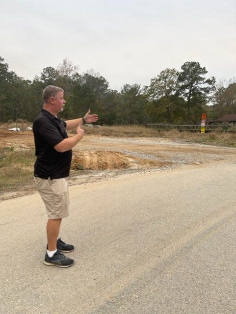 John Wineman stands outside on Forest Haven Road near construction work on the Effingham Parkway.
