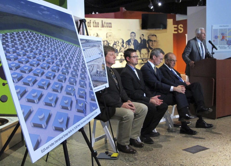 FILE - An illustration depicts a planned interim storage facility for spent nuclear fuel in southeastern New Mexico as officials announce plans to pursue a project by Holtec International during a news conference in Albuquerque, N.M., on April 29, 2015. U.S. regulators say they need more time to wrap up a final safety report and make a decision on whether to license a multibillion-dollar project meant to temporarily store tons of spent fuel from commercial nuclear power plants around the nation. The Nuclear Regulatory Commission issued a new schedule Monday, citing unforeseen staffing constraints. (AP Photo/Susan Montoya Bryan, File)