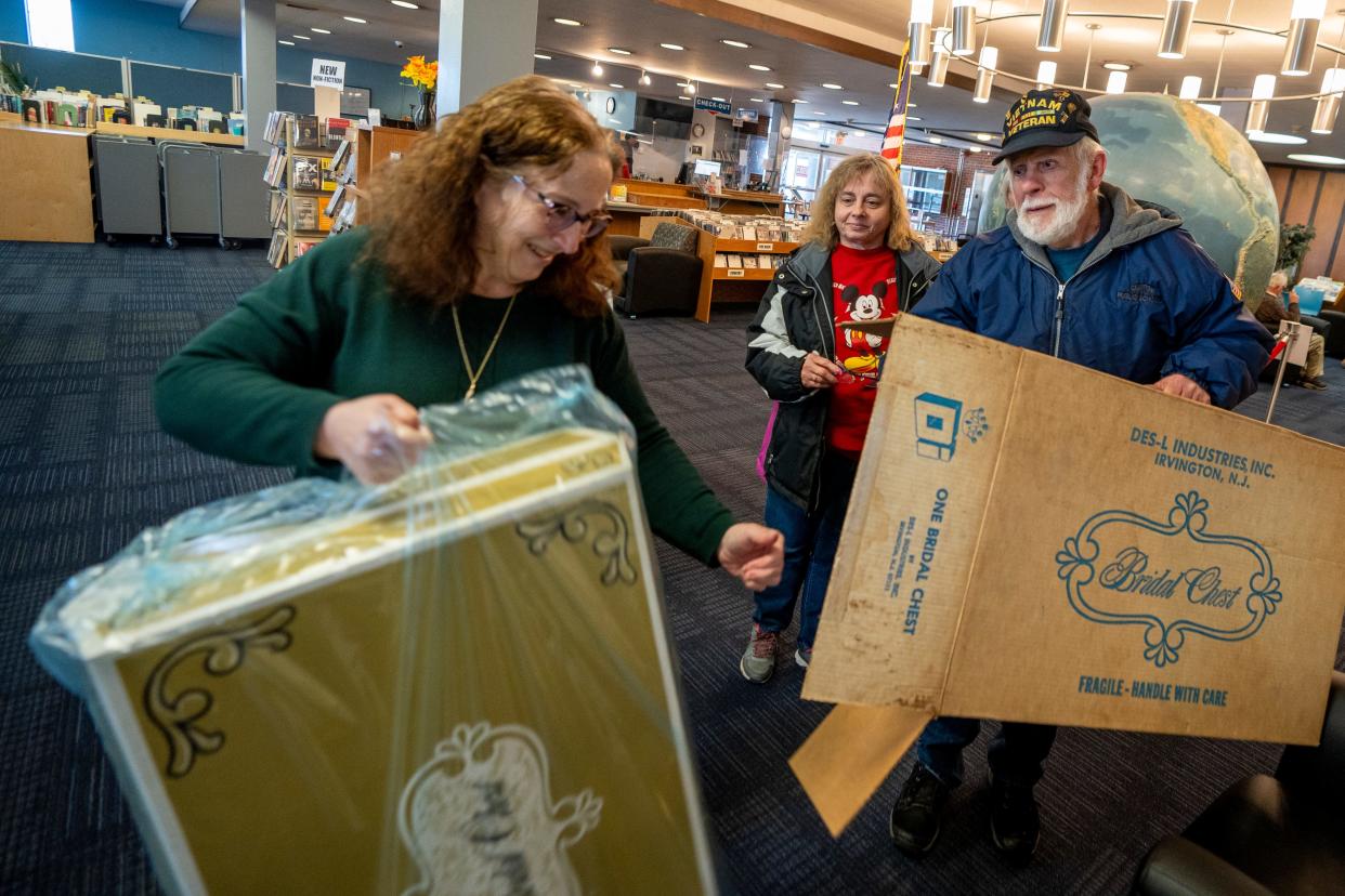 Apr 4, 2024; Fair Lawn, NJ, United States; The Maurice M. Pine Free Public Library has a lending library of wedding dresses. Library Director Adele Puccio accepts a wedding dress donation from Cindy Hesleitner and Charles Hesleitner from North Bergen.