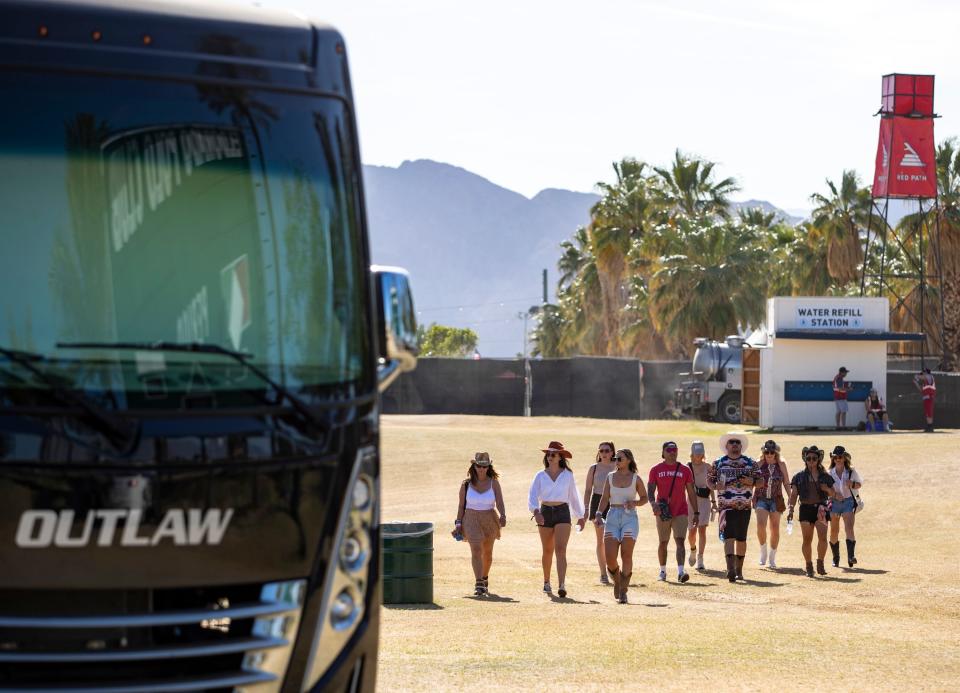 Festivalgoers make their way toward the festival grounds through The Resort camping area at Stagecoach at the Empire Polo Club in Indio, Calif., Saturday, April 29, 2023. 