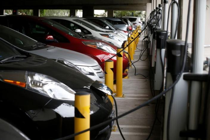 FILE PHOTO: Electric cars sit charging in a parking garage at the University of California, Irvine