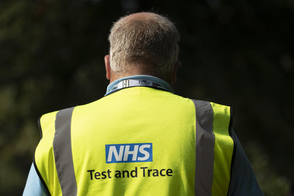 LONDON, ENGLAND - SEPTEMBER 15: A worker wearing an NHS Test and Trace tabard waits to deal with members of the public at a Covid Test site in South London on September 15, 2020 in Greater London England. The site saw a steady stream of drive in traffic, but only a small handful of walk-ins over the course of the first hour of opening. The Department Of Health has appealed to Britain's biomedical sector for 400 further laboratory technicians as the nation's return to school increases demand for Covid-19 tests. (Photo by Dan Kitwood/Getty Images)