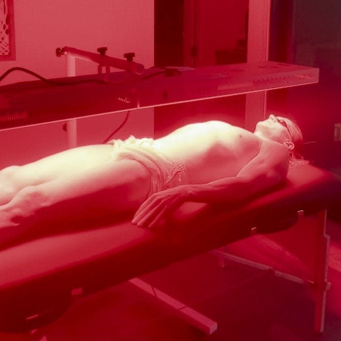 Mr Johnson, supine, wearing a loincloth that barely conceals his groin, basks in the red glow of his intense pulsed light treatment