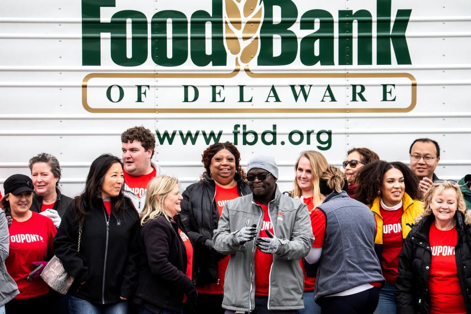 Volunteers stand in front of the Delaware Food Bank's truck at the conclusion of the bumper to bumper drive-thru event at Deltech Stanton in Newark, Friday, March 31, 2023. There was a high turnout at the event due to expiration of the COVID-19 pandemic emergency SNAP benefits.