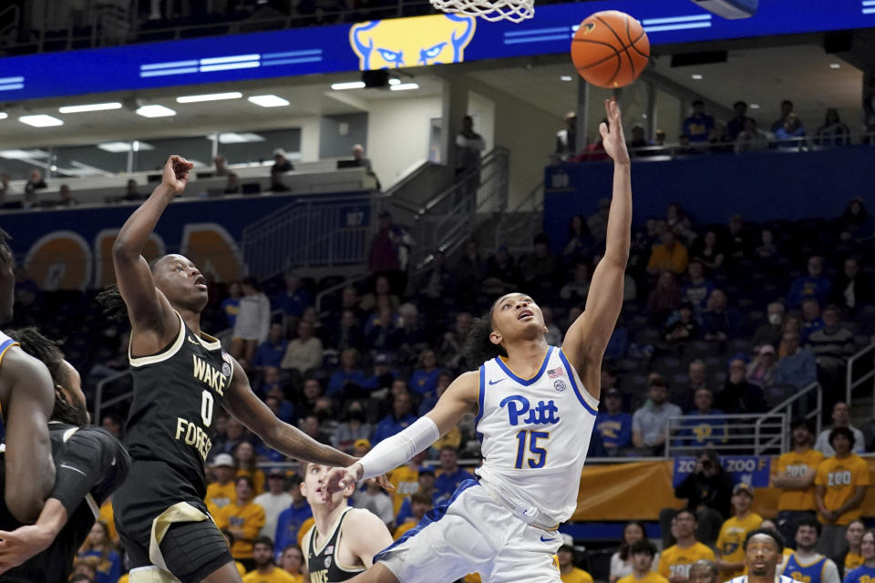 Pittsburgh guard Jaland Lowe (15) lays the ball up as Wake Forest guard Kevin Miller (0) defends during the first half of an NCAA college basketball game Wednesday, Jan. 31, 2024, in Pittsburgh. (AP Photo/Matt Freed)