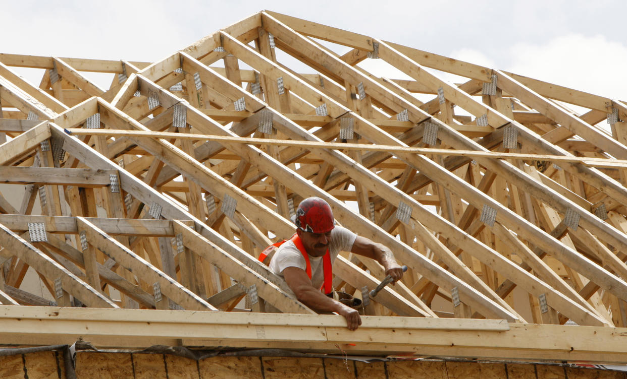 A construction worker swings his hammer at a new home development in Ottawa July 9, 2008. The number of housing starts dropped in June but the previous month's figure was upwardly revised, which convinced economists the sector is not headed for a U.S.-style meltdown.       REUTERS/Chris Wattie       (CANADA)