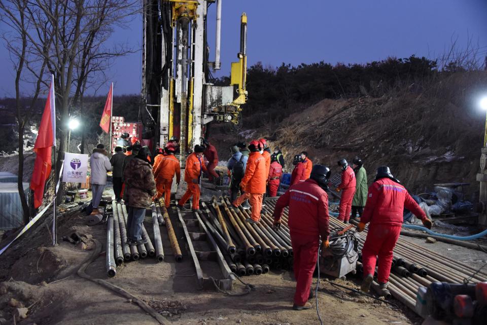 Rescuers drive a casing pipe down to establish a connection channel with trapped miners at the explosion site of a gold mine in Qixia City, east China's Shandong Province, January 17, 2021. / Credit: Xinhua/Wang Kai/Getty